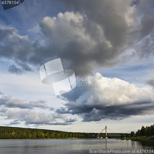 Image of The sky with clouds and a bridge over the river. Finland