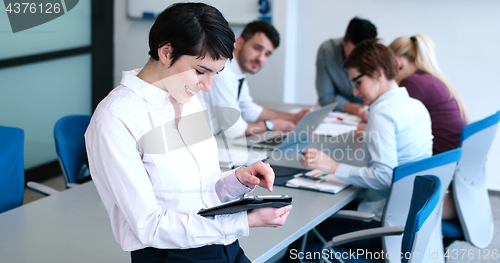 Image of Portrait of  smiling casual businesswoman using tablet  with cow