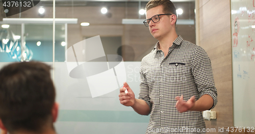 Image of young businessman in startup office