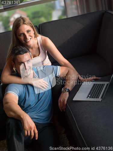 Image of Attractive Couple Using A Laptop on couch