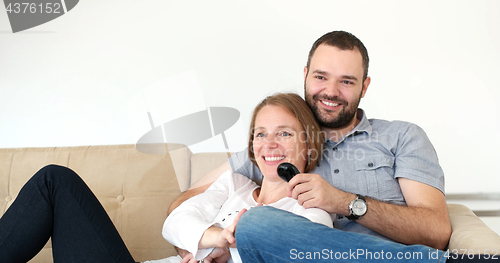 Image of senoior couple watching tv in modern villa