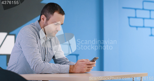 Image of Senior businessman  using cell phone at  stratup office