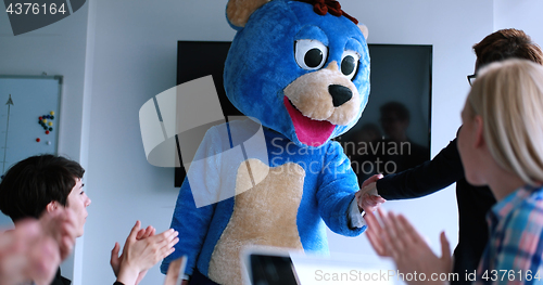 Image of boss dresed as bear having fun with business people in trendy of