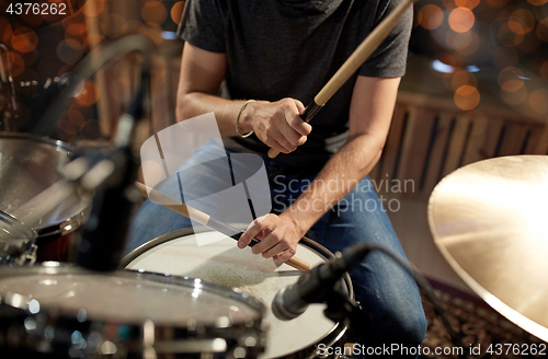 Image of male musician playing drum kit at concert