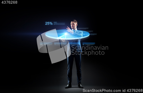 Image of businessman in suit working with virtual pie chart