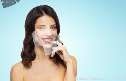 Image of beautiful smiling young woman with red lipstick