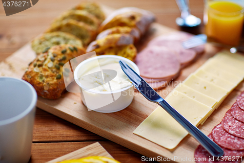 Image of cream cheese and other food on table at breakfast