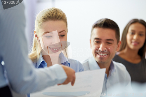 Image of group of smiling businesspeople at office