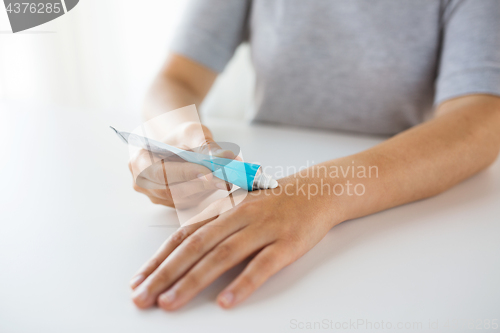 Image of close up of hands with cream or therapeutic salve