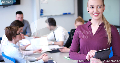 Image of Pretty Businesswoman Using Tablet In Office Building during conf