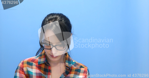 Image of woman smiling wearing on a pair of large glasses