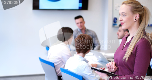 Image of Pretty Businesswoman Using Tablet In Office Building during conf