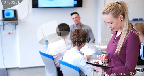 Image of Pretty Businesswoman Using Tablet In Office Building during conf