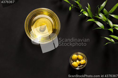 Image of Olive oil and olive branch on the wooden table