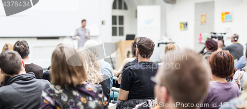 Image of Man giving presentation in lecture hall at university.