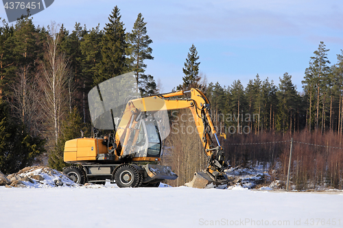 Image of Hydraulic Excavator at Rural Construction Site in Winter