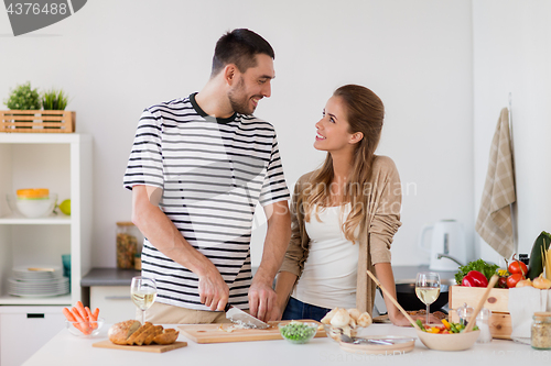 Image of couple cooking food at home kitchen