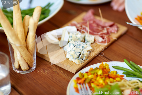 Image of blue cheese and breadsticks on table