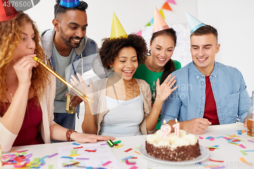 Image of team greeting colleague at office birthday party