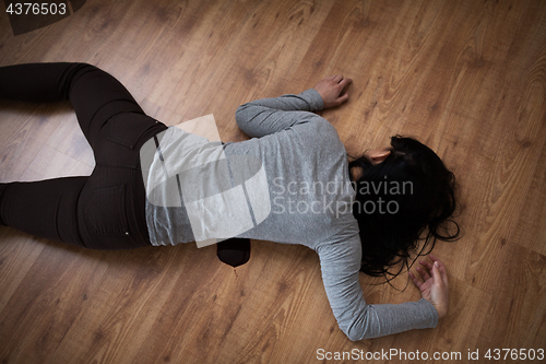 Image of dead woman body in blood on floor at crime scene