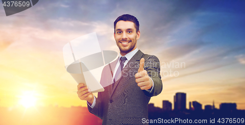 Image of smiling businessman with tablet pc computer