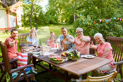 Image of happy family having dinner or summer garden party