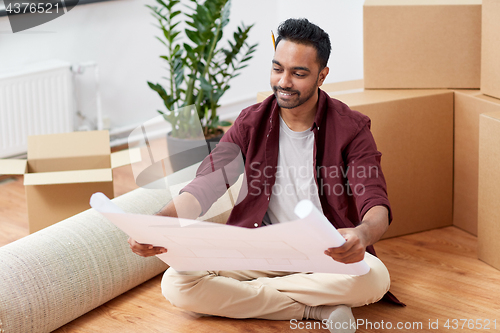 Image of man with boxes and blueprint moving to new home