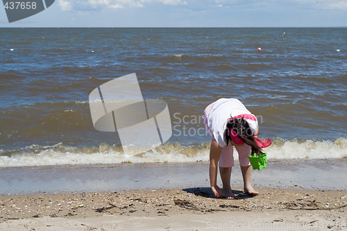 Image of Girl Collecting Seashells