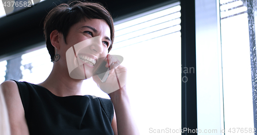 Image of Business Girl Standing In A Modern Building Near The Window With