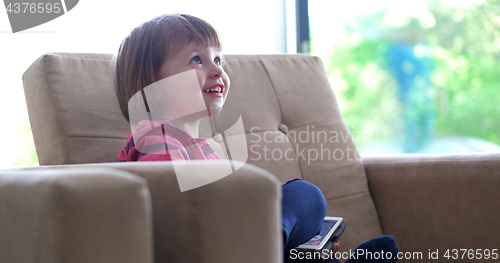 Image of Child using tablet in modern apartment