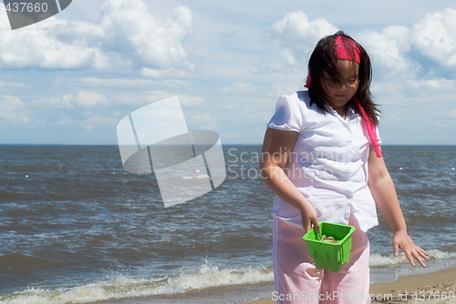 Image of Girl Collecting Rocks