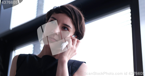 Image of Business Girl Standing In A Modern Building Near The Window With