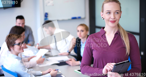 Image of Pretty Businesswoman Using Tablet In Office Building during conf