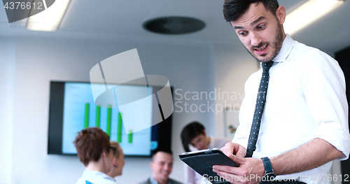 Image of Businessman using tablet in modern office