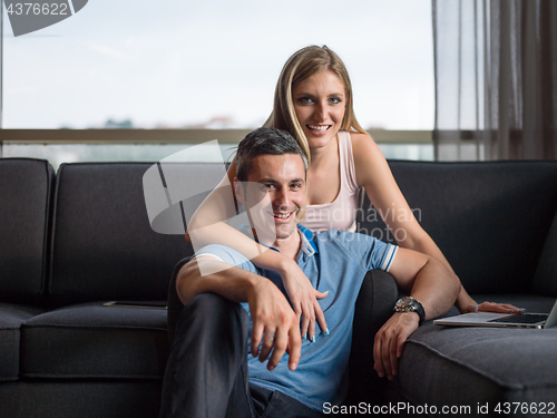 Image of Attractive Couple Using A Laptop on couch