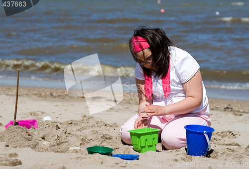 Image of Girl Making Sand Castle