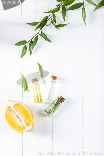 Image of Lemon oil isolated on white wooden table