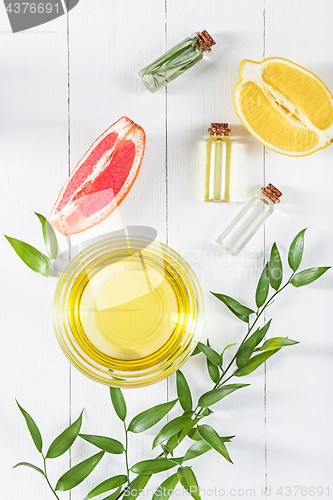 Image of Lemon oil isolated on white wooden table