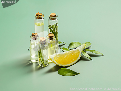 Image of Lemon oil isolated on white wooden table