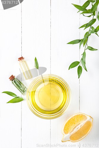 Image of Lemon oil isolated on white wooden table