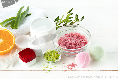 Image of Spa concept with salt, mint, lotion, towel on white background