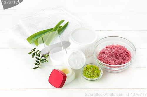 Image of Spa concept with salt, mint, lotion, towel on white background