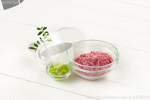 Image of Spa concept with salt, mint, lotion, towel on white background