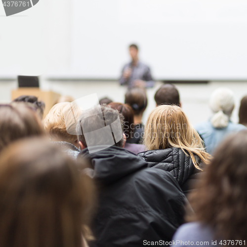 Image of Man giving presentation in lecture hall at university.