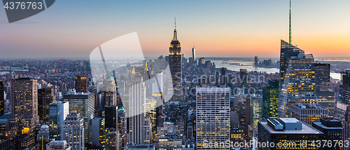 Image of New York City skyline with urban skyscrapers at dusk, USA.