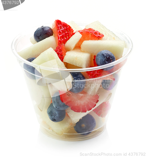 Image of fresh fruit pieces salad in plastic cup