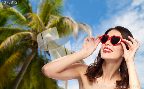 Image of woman with red lipstick and heart shaped shades