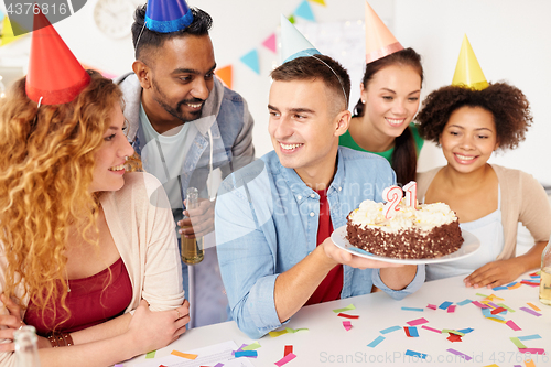 Image of team greeting colleague at office birthday party