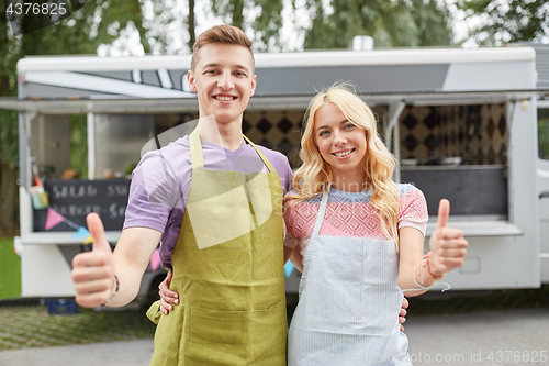 Image of couple of sellers at food truck showing thumbs up