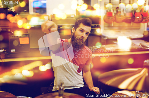 Image of male musician playing drum kit at music store